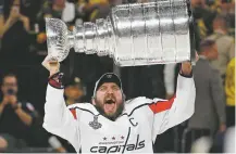  ?? JOHN LOCHER/ASSOCIATED PRESS ?? Capitals left wing Alex Ovechkin hoists the Stanley Cup after Washington defeated the Knights in Game 5 of the Final on Thursday in Las Vegas, Nev.