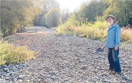  ?? CAROL VALENTINE VIA AP ?? Jack Dwyer stands on the dry creek bed of Deer Creek in Selma, Oregon. Illegal marijuana growers stole water from the stream.