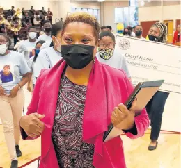  ?? JOHN SMIERCIAK/DAILY SOUTHTOWN ?? Cheryl Frazier, director of speech and forensics at Southland College Prep in Richton Park, leaves a surprise rally last week where she was announced as the Illinois Network of Charter Schools Lifetime Achievemen­t Award winner.