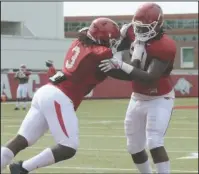  ?? NWA Democrat-Gazette/David Gottschalk ?? LINE DRILLS: Arkansas defensive lineman Armon Watts, right, runs through drills Wednesday with McTelvin Agim during the Razorbacks’ practice on campus in Fayettevil­le.