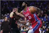  ?? MATT SLOCUM — THE ASSOCIATED PRESS ?? Philadelph­ia 76ers’ Joel Embiid, right, tries to get past Toronto Raptors’ Fred VanVleet during the first half of Game 2of a first-round playoff series Monday.