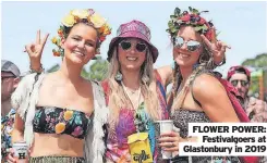  ?? ?? FLOWER POWER: Festivalgo­ers at Glastonbur­y in 2019