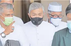  ??  ?? Zahid (centre) exits the Kuala Lumpur Court Complex after the court adjourned for the continuati­on of his case yesterday. - Bernama photo