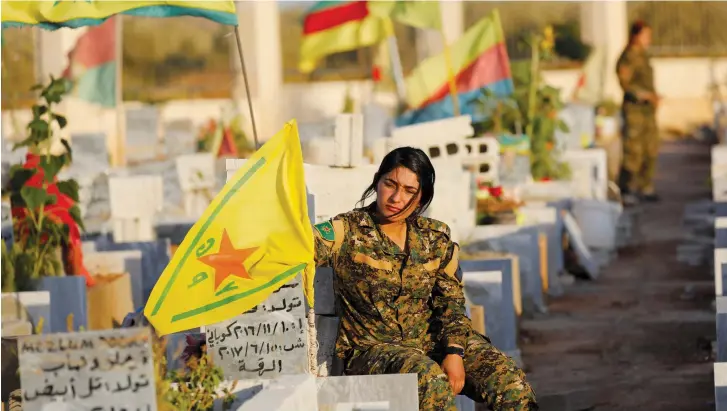  ??  ?? A MEMBER of the Syrian Democratic Forces mourns at the grave of a fallen comrade.
