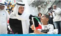  ?? ?? Faisal Saeed Al-Ghareeb, Minister of Justice, Minister of Awqaf and Islamic Affairs talks to one of the children.