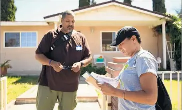  ?? Christina House For The Times ?? DEREK BRYSON, left, and Pamela Sparrow go door to door in Simi Valley. Both worked as paid field organizers for Hillary Clinton in Las Vegas, leaving California for a swing state that Democrats needed to win.