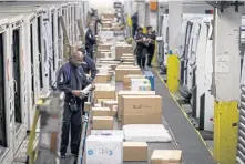  ?? GETTY IMAGES PHOTOS ?? EASY SHOPPING: FedEx employees sort packages for delivery at a shipping center last year. This year, Cyber Monday sales, sometimes spanning the whole week, below, are forecast to hit $7.8 billion, according to Adobe Analytics.