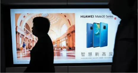  ?? AP PHOTO ?? People walk past an advertisem­ent for Huawei at a subway station in Hong Kong on Thursday. Canadian authoritie­s said Wednesday that they have arrested Huawei’s chief financial officer Meng Wanzhou for possible extraditio­n to the United States.