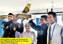  ??  ?? Royal players celebrate winning the Ray Wijewarden­e Trophy as Anoma Wijewarden­e looks on