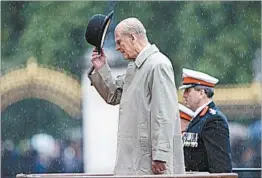  ?? YUI MOK/GETTY ?? Prince Philip honors Royal Marines during a parade Wednesday at Buckingham Palace.