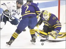  ?? Arnold Gold / Hearst Connecticu­t Media ?? Quinnipiac’s Karlis Cukste, center, and goalie Andrew Shortridge defend against Yale’s Chander Lindstrand at Ingalls Rink on Saturday.