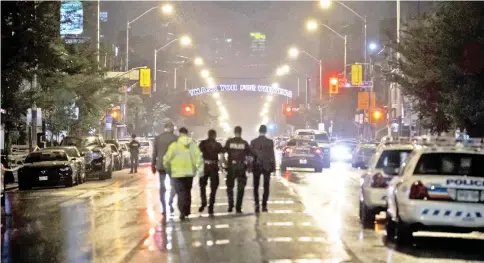  ??  ?? Toronto police officers work at the scene of the shooting in Greektown,Toronto. — AFP photo