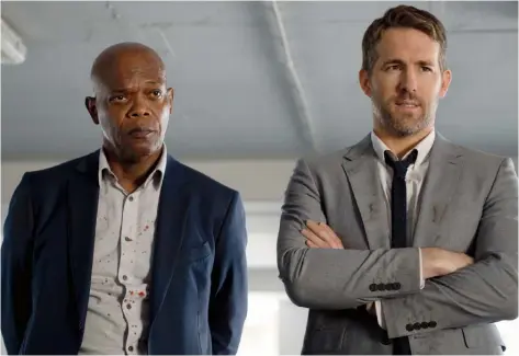  ?? LIONSGATE ?? Samuel L. Jackson, left, and Ryan Reynolds team up in the action-comedy-drama The Hitman’s Bodyguard.