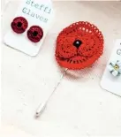  ??  ?? A matching poppy lapel pin and earrings. The earrings are fixed to a disc with a silver post and scroll by a glue which needs a full day to ‘cure’; the chemical reaction causing it to solidify.