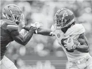  ?? James Gilbert / Tribune News Service ?? Alabama’s John Metchie III runs for yardage against Florida’s Tre’Vez Johnson on Saturday.