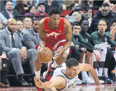  ?? STEVE RUSSELL TORONTO STAR ?? Raptors guard Kyle Lowry gets past Milwaukee Bucks centre Brook Lopez on Thursday night at Scotiabank Arena.
