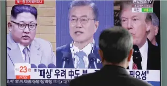  ?? LEE JIN- MAN/ AP ?? A man watches a TV screen showing file footage of ( from left) North Korean leader Kim Jong Un, South Korean President Moon Jae- in and President Donald Trump in Seoul, South Korea.
