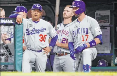  ?? John Minchillo The Associated Press ?? National League manager Dave Roberts (30) and Las Vegan Kris Bryant (17) of the Chicago Cubs in the fifth inning Tuesday. Despite losing, Roberts said, “It was great to see all the talent, the stars, and I enjoyed the experience.”