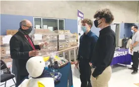  ?? David Wilson/appeal-democrat ?? Edward Han, regional sales director with Aflac Insurance in Yuba City (left), speaks with Damian Wagner (center) and Micah Henry at the Yuba-sutter Job Fair in Yuba City on Thursday.