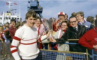  ?? ?? Below: McGhee shows the cup to fans from the St Clair when it docked in Aberdeen.