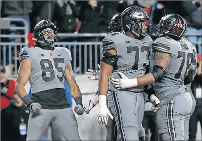  ?? QUILTER/DISPATCH] [JONATHAN ?? Tight end Marcus Baugh, left, celebrates his winning touchdown catch with 1:48 remaining in the game.