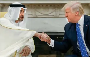  ?? AP ?? THEIR FIRST HANDSHAKE: US President Donald Trump receives Sheikh Mohamed bin Zayed in the Oval Office of the White House in Washington on Monday ahead of their talks. —