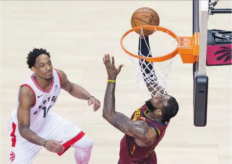  ?? TYLER ANDERSON ?? DeMar DeRozan watches as Cleveland superstar LeBron James puts home two of his 43 points Thursday as the Cavaliers pulled away in the second half for a 128-110 win to take a 2-0 lead in the Eastern Conference second-round series, which moves to...