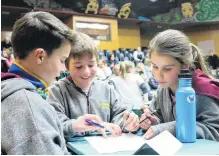  ?? PHOTOS: TOM KITCHIN ?? Thinking about it . . . Glenorchy Primary team (from left) Harley Davies (13), Sam Glover (12) and Ruby Davies (11) put their heads together to come up with the answer.