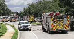  ?? Michael Fisher / Staff ?? Hazmat units with the Fire Department responded Thursday as police detected carbon monoxide coming from the house on the North Side.