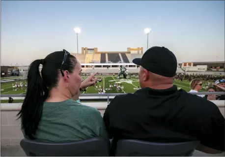  ?? NATHAN HUNSINGER — THE ASSOCIATED PRESS ?? Lisa DeMarco and Rey Martinez watch students on the field during the opening of the new Children’s Health Stadium at Prosper ISD on Saturday in Prosper, Texas.