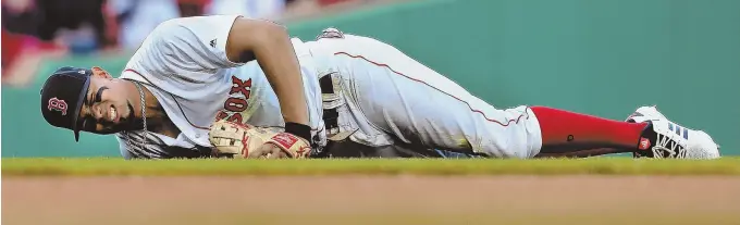  ?? STAFF PHOTO BY MATT WEST ?? HARD LESSON: Xander Bogaerts grimaces after trying to catch a bloop infield single by Tampa’s Matt Duffy in the sixth inning yesterday. After a visit from the trainer, he remained in the game — just his second since coming off the disabled list.