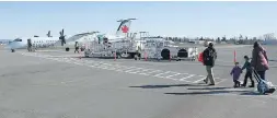  ??  ?? Passengers at Victoria Internatio­nal Airport board a flight to Vancouver.