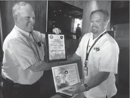  ?? Buy this photo at YumaSun.com PHOTO BY MARA KNAUB/YUMA SUN ?? JAMES “JIM” MCDERMOTT (left), longtime pilot, flight instructor and airplane mechanic, accepts the Wright Brothers Master Pilot Award and the Charles Taylor Master Mechanic Award from Scott Hutson of the Federal Aviation Administra­tion Safety Team,...