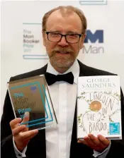  ?? — AP ?? Author George Saunders of the United States with his book Lincoln in the Bardo during a photocall after being announced winner of the 2017 Man Booker Prize in London