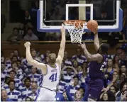  ?? GERRY BROOME — THE ASSOCIATED PRESS ?? Stephen F. Austin forward Nathan Bain drives for the game-winning basket past Duke forward Jack White during overtime in Durham, N.C., on Nov. 26, 2019.