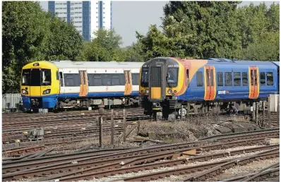  ?? JACK BOSKETT/ RAIL. ?? London Overground 378209 approaches Clapham Junction on September 9 2014, as South West Trains 450081 passes bound for London Waterloo. Under proposals by Government and Transport for London, some services from Waterloo operated currently by...