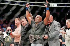  ?? [AP PHOTO] ?? Former Oklahoma State wrestling standout Daniel Cormier celebrates after defeating Stipe Miocic in a heavyweigh­t title mixed martial arts bout at UFC 226 on Saturday night in Las Vegas.