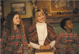  ??  ?? Hawn, as Mrs. Claus, in a scene with Darby Camp ( left) and Jahzir Bruno in the family adventure/ comedy “The Christmas Chronicles 2.”