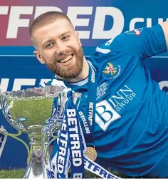  ??  ?? Saints goal hero Shaun Rooney with the League Cup.