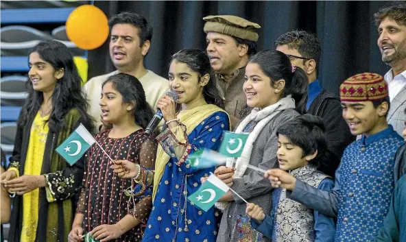  ?? PHOTOS: MURRAY WILSON/STUFF ?? Abeeha Qazafi leads a Pakistani song as Palmerston North Muslims welcome all comers to their Eid Adha celebratio­ns.