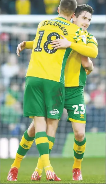  ??  ?? WELL DONE, PAL: Norwich City’s Kenny McLean is congratula­ted on his winner