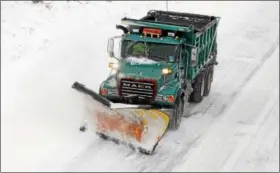  ?? DIGITAL FIRST MEDIA FILE PHOTO ?? A PennDOT plow removes some of the snow from the road surface and spreads salt on the Route 1 Bypass near the University Road overpass in Chester County.