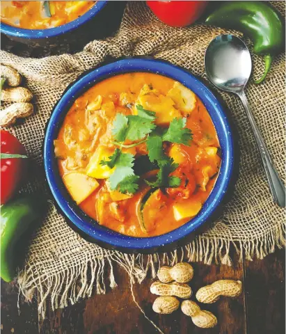  ?? RENEE KOHLMAN ?? This vegetable stew in a spicy peanut sauce warms from the inside out, so don’t be afraid to turn up the heat when the weather turns cold and you start to feel really chilly.