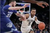  ?? JULIO CORTEZ — THE ASSOCIATED PRESS ?? Villanova guard Phil Booth (5) drives against Seton Hall forward Sandro Mamukelash­vili (23) during the first half of the Big East Conference championsh­ip game, Saturday in New York.