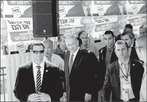  ?? AP/OLIVIER FITOUSSI ?? Israeli Prime Minister Benjamin Netanyahu (center) visits a constructi­on site Monday in Har Homa, east Jerusalem, a day ahead of legislativ­e elections.