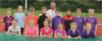  ??  ?? Coach Liam Kelly with the high jump crew at the Athletics Wexford summer camp.