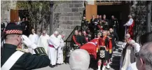  ?? ANDREW MCLAUGHLIN SPECIAL TO TORSTAR ?? Clergy and soldiers pay their respects as the coffin of Canon Robert Fead leaves Christ’s Church Cathedral after his funeral.