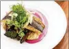  ?? CONTRIBUTE­D BY HENRI HOLLIS ?? Seared black sea bass at Mission and Market is served with roasted vegetables atop a bright pink swath of beet raita.