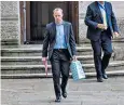  ??  ?? Dominic Raab arriving at Downing Street with a gift for baby Wilfred yesterday