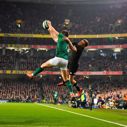  ??  ?? LIGHTER THAN AIR: Jacob Stockdale of Ireland and Damian McKenzie of New Zealand take flight. Photo: Brendan Moran